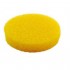 Una esponja de limpieza redonda, de color amarillo, con una piedra blanca sobre un fondo blanco.