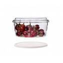 Recipiente de borosilicato con pimientos rojos, tapa flotante debajo.