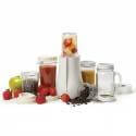 Licuadora personal Tribest Batidora con frutas y granos de café sobre fondo blanco.