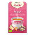 Caja de Yogi Tea Mujer sobre fondo rosa, adornada con arte herbal para el bienestar.
