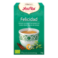 Caja de Té Verde Yogi etiquetada “Felicidad”, con taza y hierbas, prometiendo bienestar.
