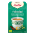 Caja de Té Verde Yogi etiquetada “Felicidad”, con taza y hierbas, prometiendo bienestar.