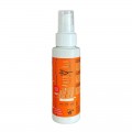 Botella de protector solar de color naranja con bomba, etiquetada "Anthyllis FPS 50" y "crema fluida solar".