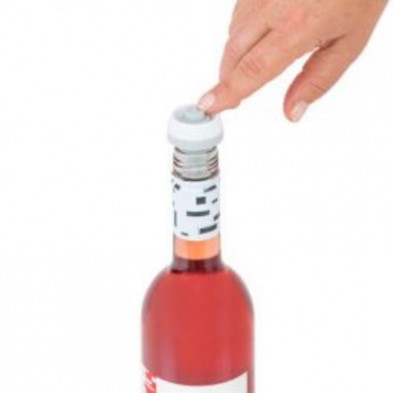 Accionando un tapón de vacío de Status para poder abrirlo y usar el vino de la botella