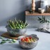 Escurridor Inox 26 cm Lacor acompañado del escurridor de 22 cm en una encimera de cocina con alimentos.